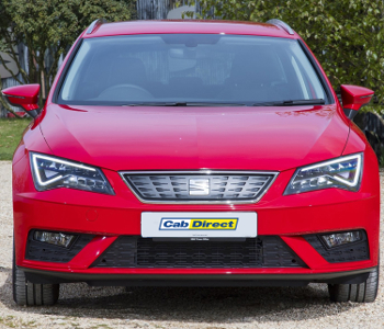 A red SEAT Leon ST taxi is parked outdoors, facing the camera with its headlights on. The number plate reads Cab Direct, and trees and a building can be seen in the background.