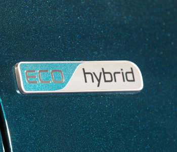 Close-up of an ECO hybrid badge on a metallic blue-green Kia Niro Hybrid, ideal for eco-friendly taxi fleets.