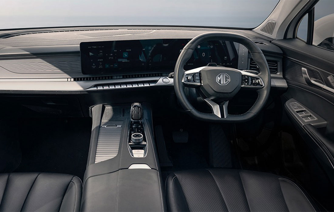 Interior of a modern MG car featuring a right-hand drive steering wheel, digital dashboard, and sleek centre console with controls, highlighted by black leather seats—ideal for taxi use.