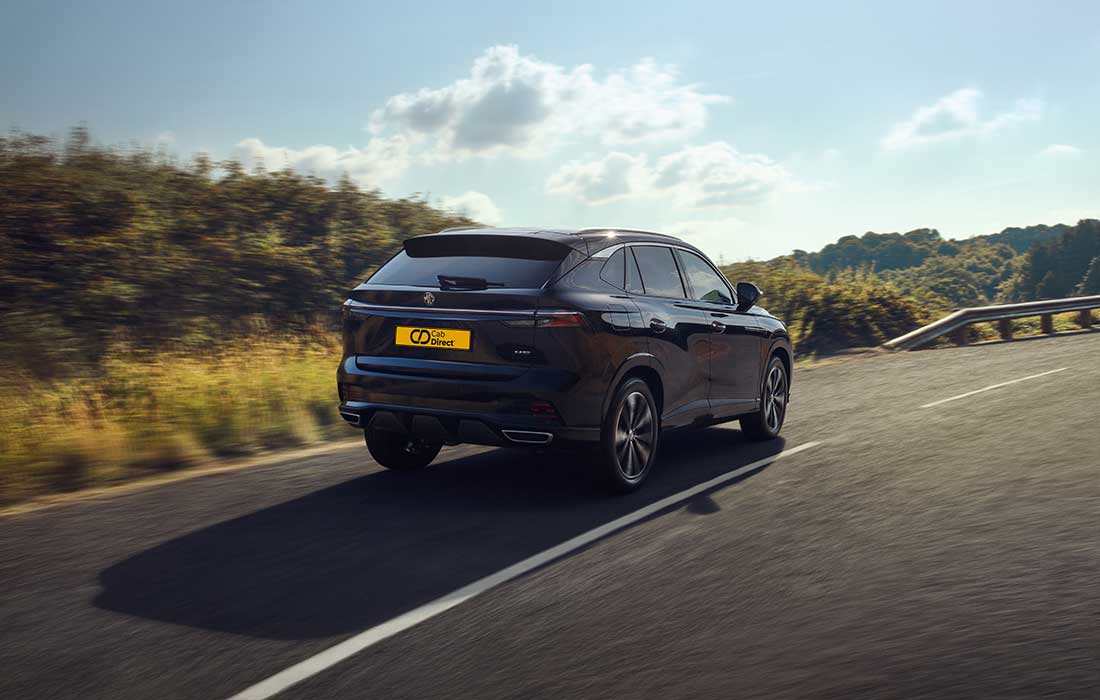 Black Peugeot 408 taxi driving on a country lane.