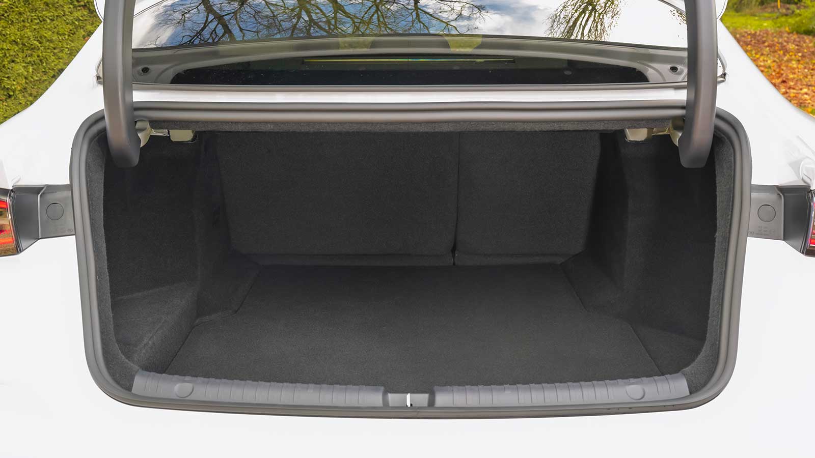Open boot of a white taxi.