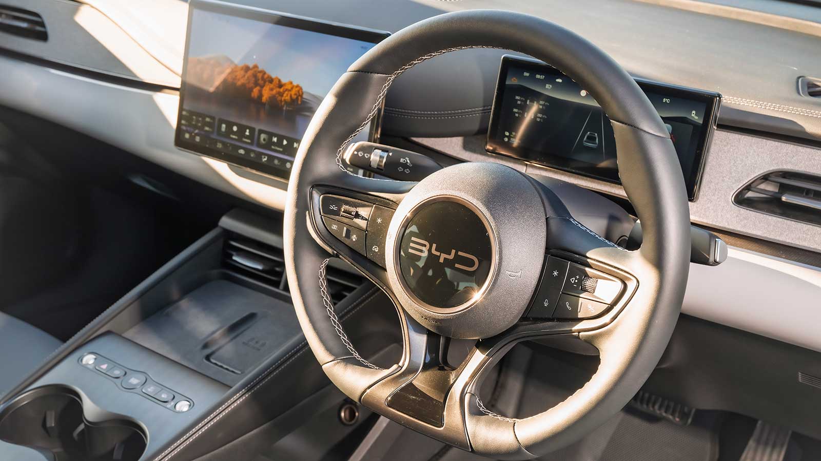 Interior of a BYD taxi featuring the steering wheel, digital dashboard, and infotainment touchscreen.