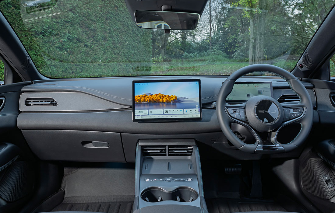 Interior of the BYD taxi, featuring a large central touchscreen and a multi-function steering wheel.