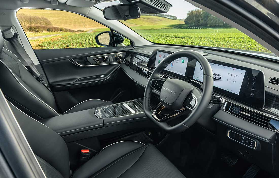 Interior view of the Omoda taxi front cabin featuring a digital dashboard and steering wheel.