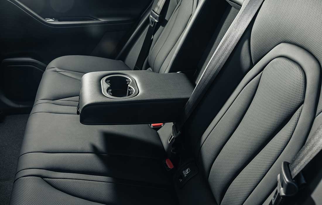 Comfortable rear taxi seats featuring a centre armrest with integrated cup holders.